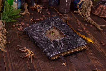 Close the book of black magic with the image of the eye of the sea monster. Mystical still life...