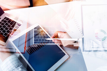 Businessman holding tablet and showing a growing virtual hologram of statistics, graph and chart with arrow up on dark background. Stock market. Business growth, planing and strategy concept.