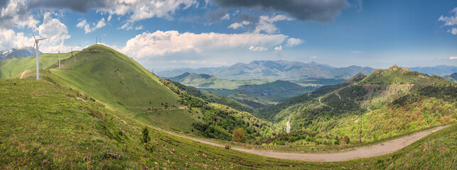 Panorama of a dirt village road leading to the Pushkin pass in the mountains of Armenia. Wind...