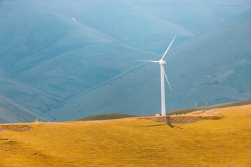 Windmill generating electricity from the energy of strong winds. Concept of a green economy and...