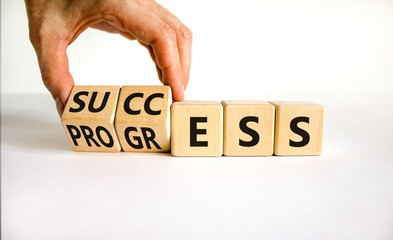 Success business progress symbol. Businessman turns wooden cubes with words 'success progress'. Beautiful white background, copy space. Success business progress concept.