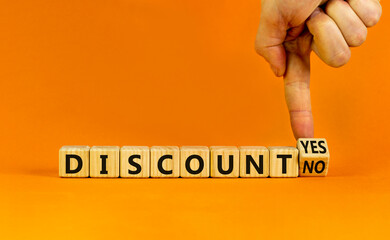 Discount symbol. Businessman turns a wooden cube and change words 'discount no' to 'discount yes'....