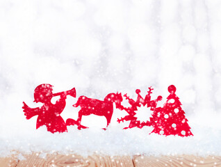 red christmas toys in the snow with on the white background with snowfall