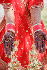 Beautiful Mehndi design on hand young bride girl  hands with henna hands with traditional Indian...