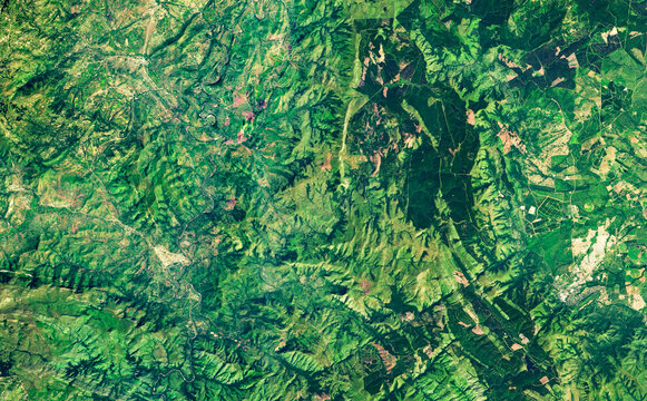 Nature pattern on satellite photo, forest taken from space in summer. Elements of this image furnished by NASA.