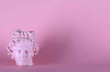 antique pink gypsum sculpture of a female head