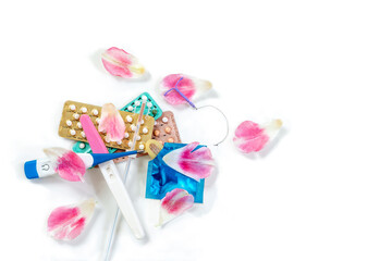 Several types of birth control method with roses petals.