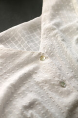Detail of white cotton blouse. Selective focus.