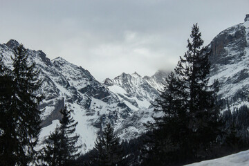 Obraz premium Winter landscape with beautiful snow-covered mountains in the clear morning sunlight. Scale reference. Swiss Alps.