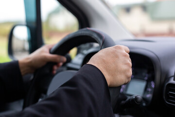 Man's hands at the wheel of a car. Safe driving. Drunk driving. Falling asleep behind the wheel.