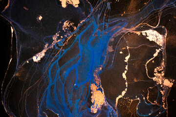 Luxury abstract fluid art painting in alcohol ink technique, mixture of white, blue and gold paints on black paper. Imitation of marble stone cut, glowing golden veins. Tender and dreamy design. - 459001653