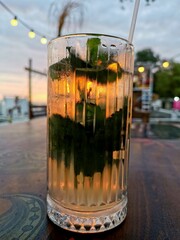 A glass of lemonade at sunset by the sea