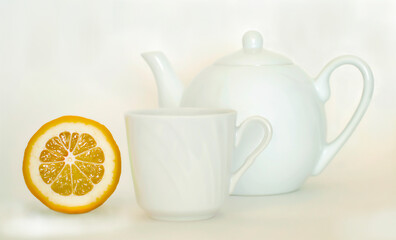 white teapot with a mug and lemon