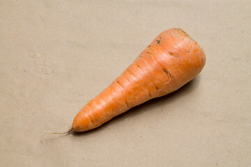 A carrot on a brown background.