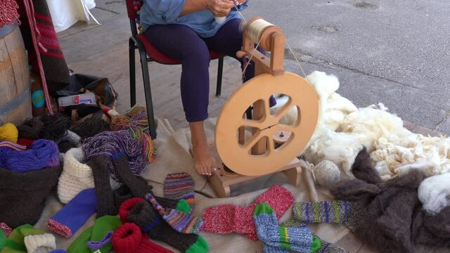 old style wool deburring , yarn making machine, spindle for making yarn, colorful wool knitted socks