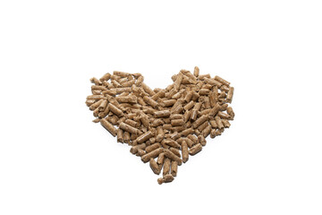 A pile of pellets in the shape of a heart, isolated on white background.
