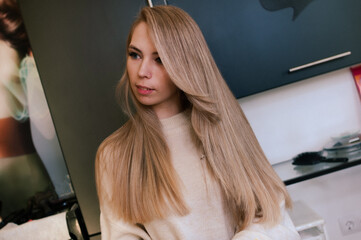 Fototapeta na wymiar Blonde girl with highlighted gorgeous long hair