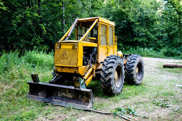 Obraz premium Forest tractor for logging after sawing trees, heavy forestry equipment