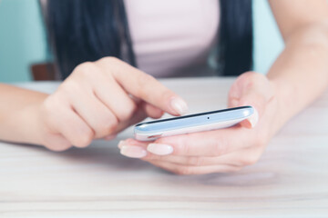 a young girl is sitting with a phone