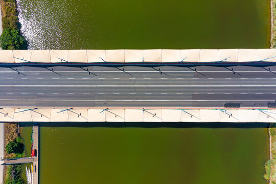 Aerial view of the bridge of Puente del Cachorro with no traffic going over the Guadalquivir river in Seville, Andalusia, Spain.