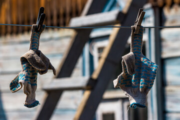 Work gloves to dry on a clothesline, reminiscent of an indecent gesture with a middle finger fuck...