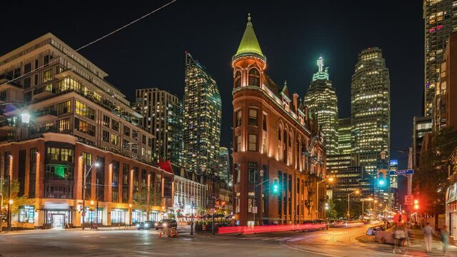 Timelapse view of Toronto cityscape and night traffic including historical landmark Gooderham Flatiron building in downtown Toronto, Ontario, Canada.