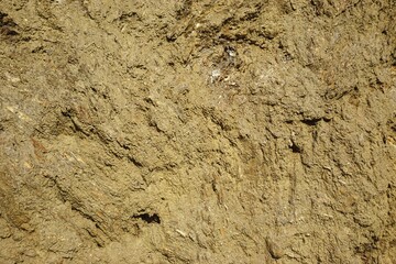 Horizontal closeup view of coarse sandy dirt pile natural gritty background texture