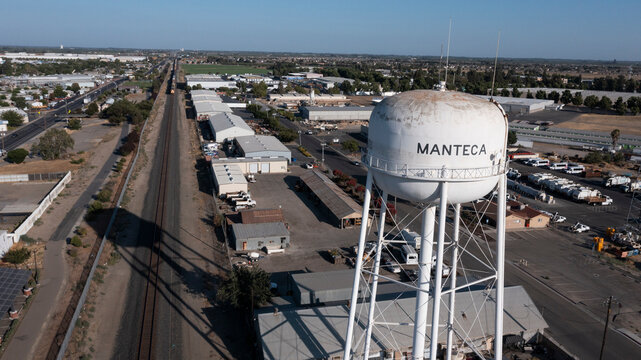 Manteca, California, USA - July 15, 2021: Afternoon sun shines on the city's famous water tower.