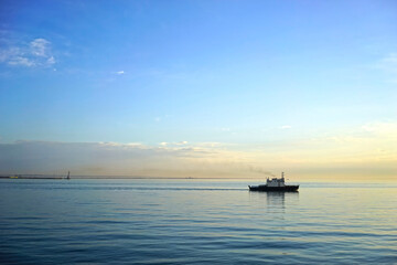 Naklejka na ściany i meble Seascape with a ship on the horizon