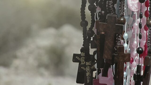 Rosary Beads with Crucifixes hanging in a Roadside Shrine dedicated to the Legendary Gauchito Gil (Argentina Robin Hood), near Tilcara, Jujuy Province, Argentina. Closeup.