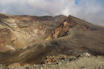 Crater of active volcano Goreliy smoke and clouds. Kamchatlka peninsula. .