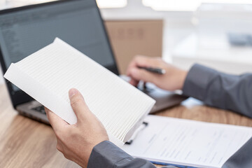 Car service staff holding new air filter of car air conditioning system and check part number from laptop : car service concept
