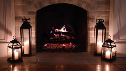 cozy fireplace at night with man putting log on fire