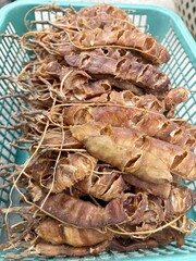 dry tamarind on green basket
