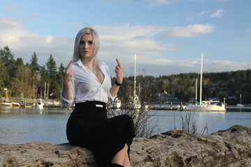 silver haired woman against gorgeous puget sound sky flipping the bird 