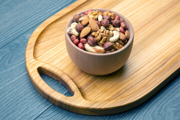 assorted nuts on a kitchen wooden board. vitamin vegetarian food