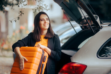 Cheerful Woman Taking Out Her Luggage from the Car Trunk 