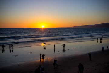 People enjoying the sunset at the beach