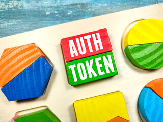 Test AUTH TOKEN writing on colored block on a wooden background