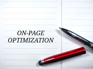 Business concept.Text ON PAGE OPTIMIZATION writing on notebook with pen.