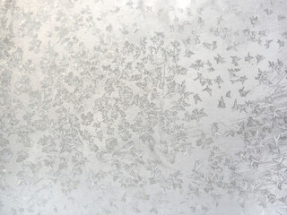 Christmas white background. Frosty pattern on glass. Wallpaper.