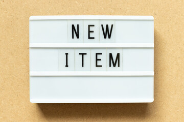 Lightbox with word new item on wood background