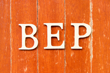 Alphabet letter in word BEP (Abbreviation of breakeven point) on old red color wood plate background
