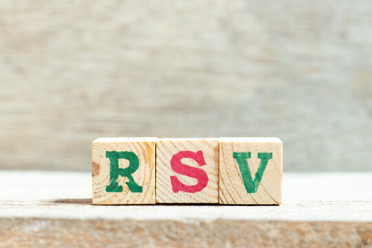 Alphabet letter block in word RSV (Respiratory syncytial virus) on wood background