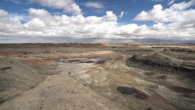 Surreal Alien Landscape Under Fluffy Clouds, Panoramic View of Dry Barren Valley and Cliffs in Bisti Badlands, De-Na-Zin Wilderness, New Mexico USA