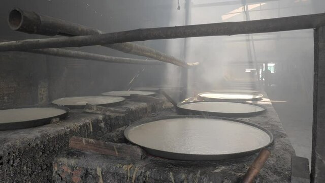 Inside a workshop during the boiling of soy milk for the making of skin tofu ( bean curd skin) 