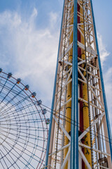 Drop tower ride and ferris wheel at amusement park