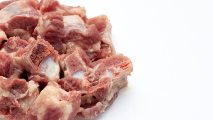 Raw pork ribs in white plate on white background.