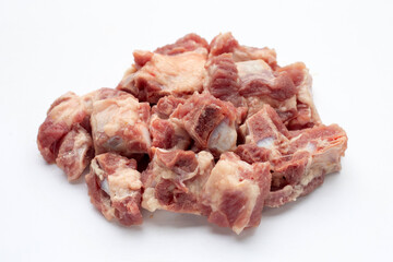 Raw pork ribs in white plate on white background.