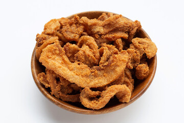 Fried crispy pork belly recipe in wooden bowl on white background.